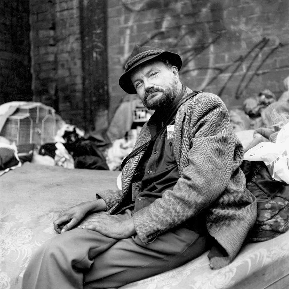 A man sitting on a couch on the street