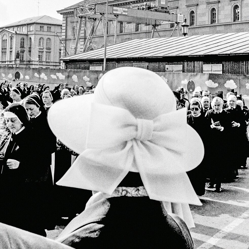 A procession of nuns crossing the street