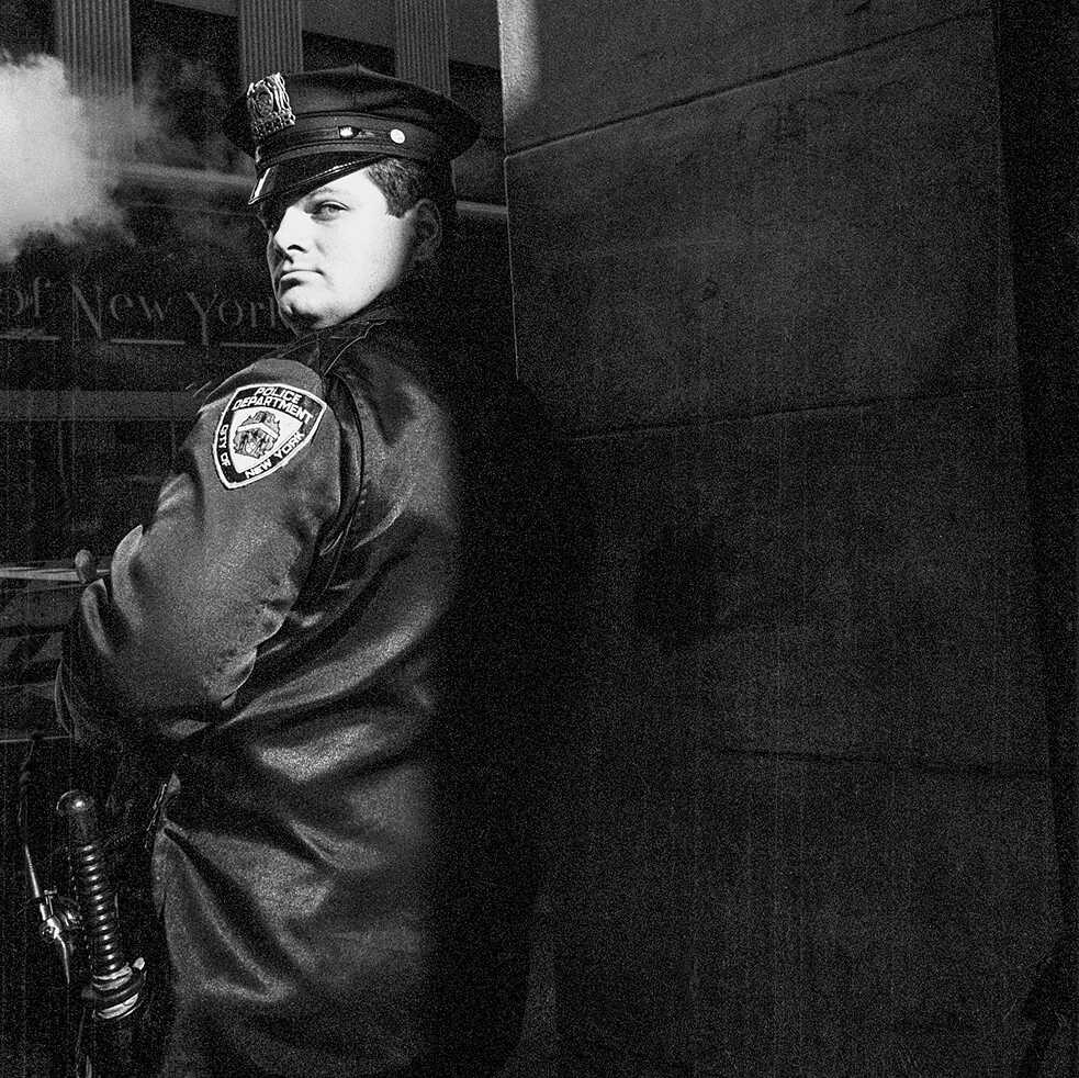 A police officer standing next to a building in New York