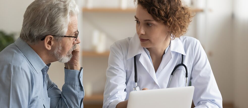 A doctor talking to an elderly patient