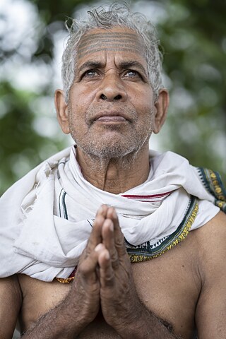 Ram Sadhak ji offers his prayers to the Almighty. The name of Ram is etched in parallel lines across his forehead.