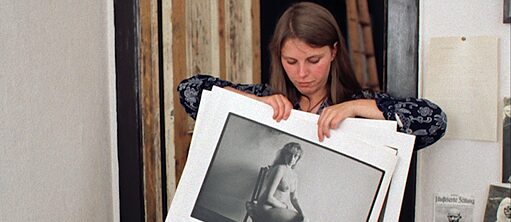 Woman holding up a photograph