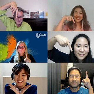 Teachers and course participants in a conferencing tool smiling and pointing in different directions during an online class