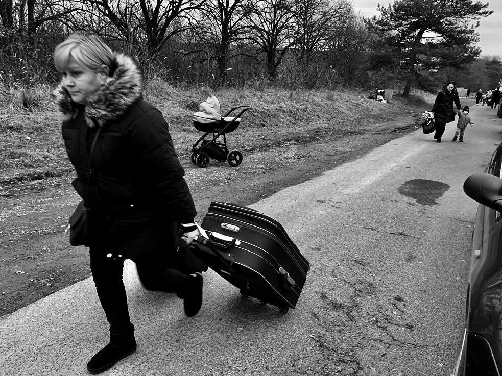 A women is pulling a suitcase 