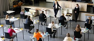 Pupils sit at separate tables