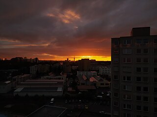 "Ich wohne in Jarov in Prag. Unsere Wohnung ist im neunten Stock und wir haben Fenster an drei Seiten. Meine Fenster ist nach Westen, ich kann den Žižkov-Turm und Wohnsiedlung sehen. Prag ist die Hauptstadt und ein Million Menschen wohnen hier."