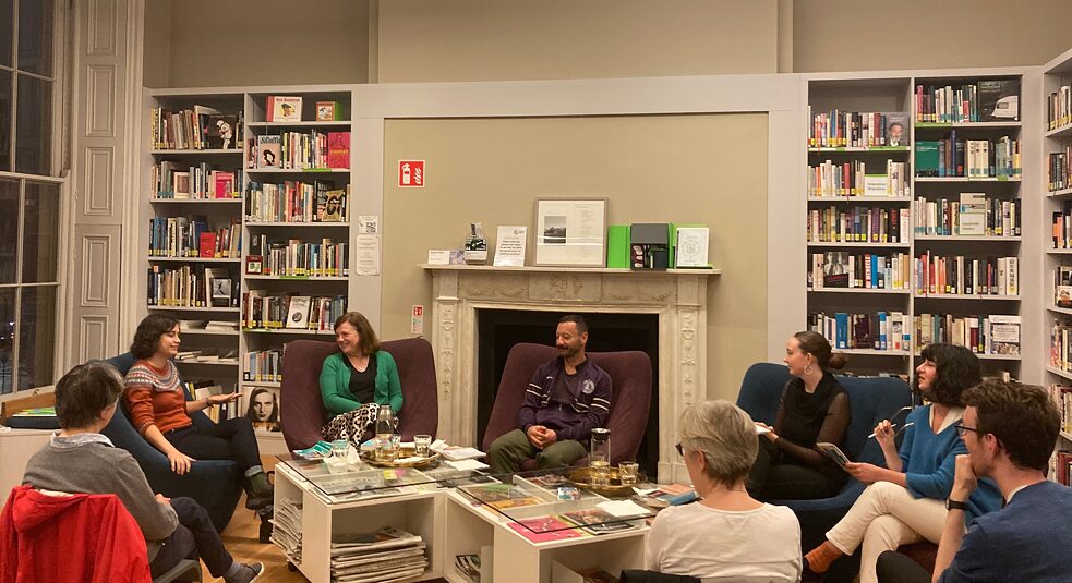 Reading and discussion in the library with audience.