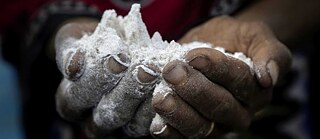 Image of hands holding flour.