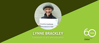 Lynne Brackley holding up a sign that says "Goethe Institute Schwäbisch Hall"