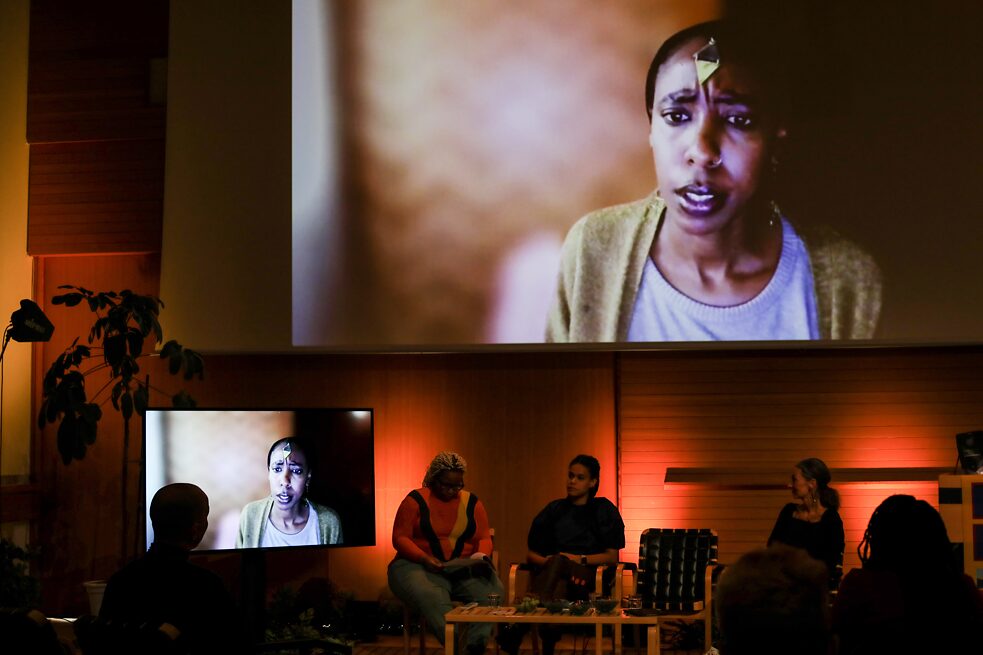 Conference stage with 4 people conversing