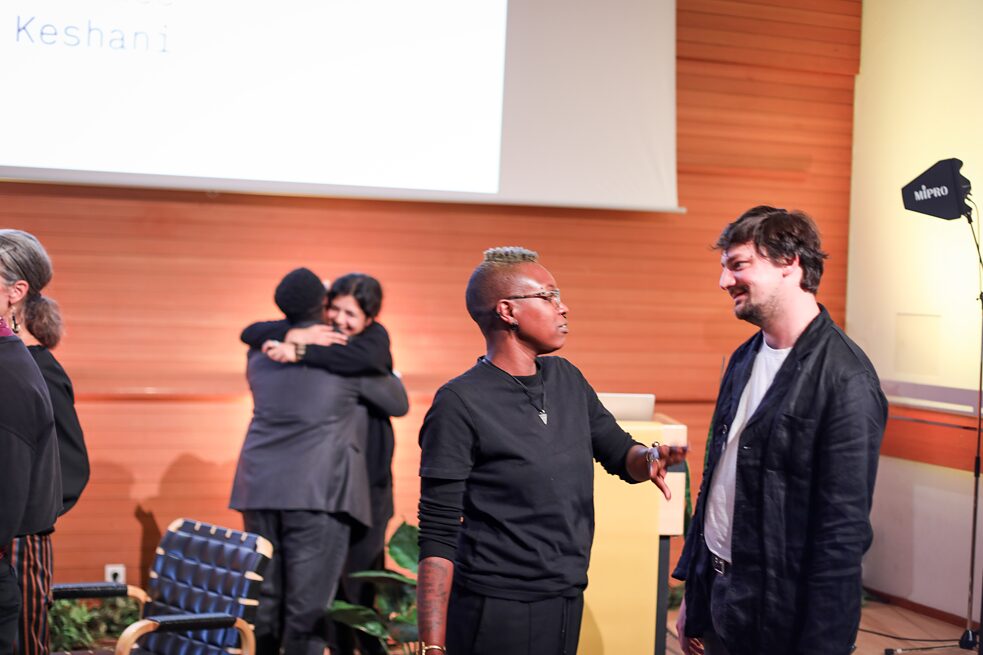People in different groups in conversation gathered on the stage