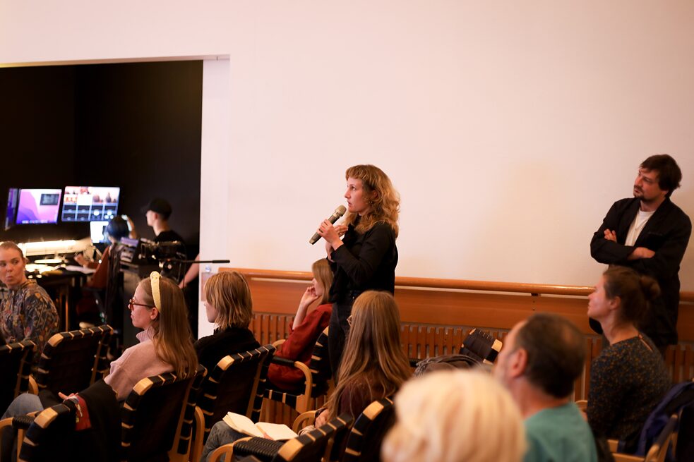 Woman in audience holding a mic