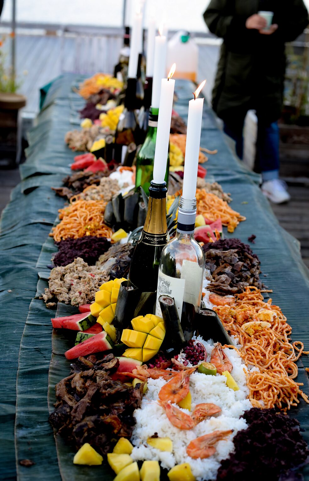 Food spread out across the table, with candles in between