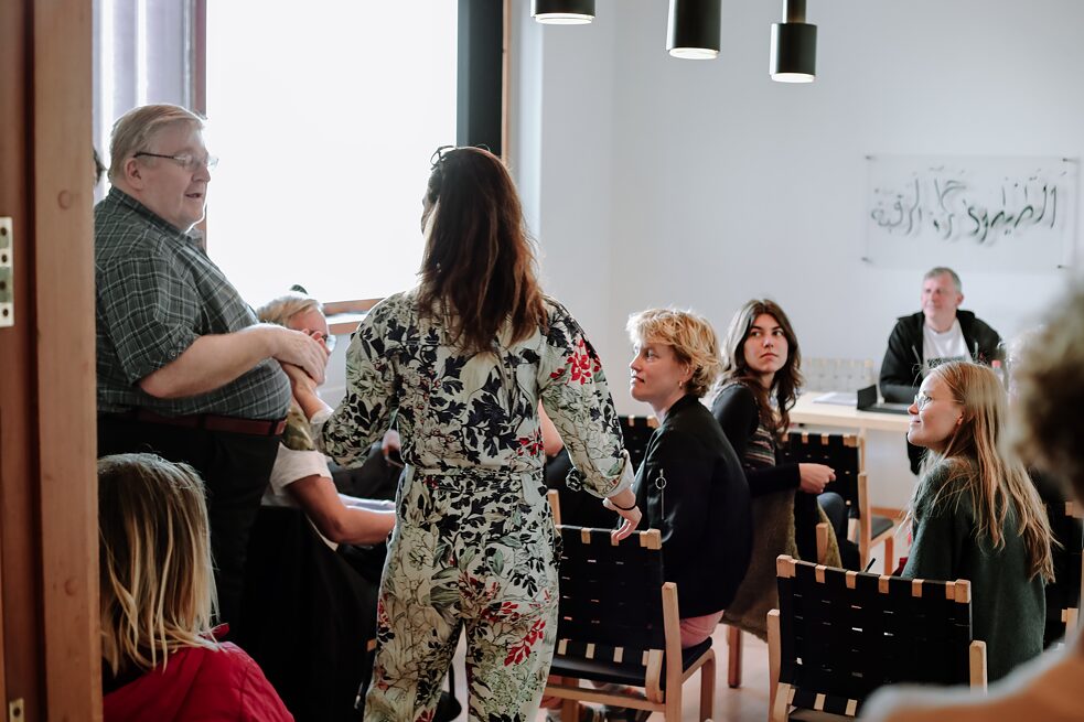 People in a room, two dancing in the crowd
