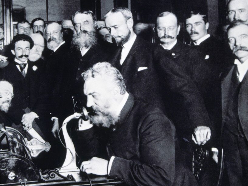 The American engineer Alexander Graham Bell (1847-1922) opening the phone line from New York to Chicago in 1892. Spanish and American illustration.