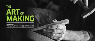 Black and white close-up of someone making the seat of a chair. The right hand is holding a hammer about to hit a wooden wedge, held by their left hand. The text on the image in green and white letters reads: The Art of Making, Exhibition, Photography & Texts by Georgios N. Paparoditis.
