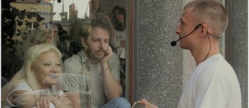 Three people talking to each other through glass