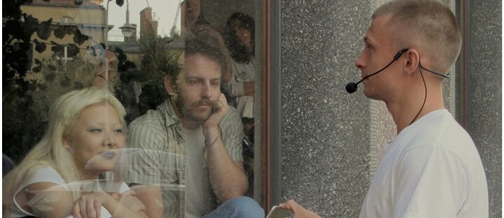 Three people talking to each other through glass