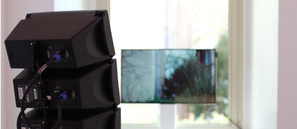 A photo of a speaker and a window as part of her exhibition