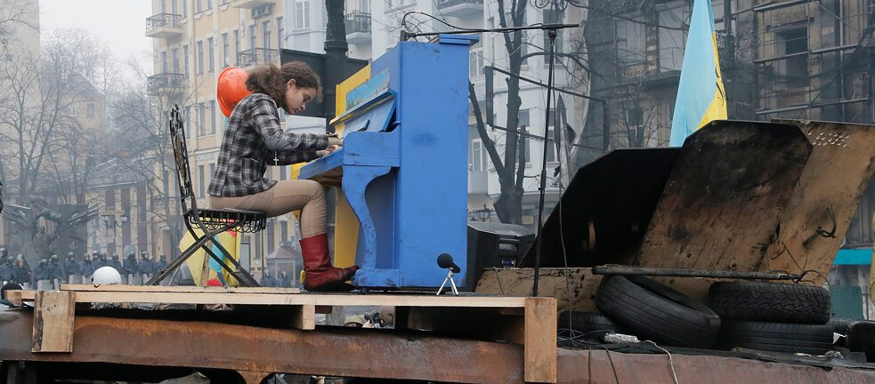 Pianist Antuanetta Mishchenko, known by many as the “muse of the Maidan”, plays the piano on a barricade in front of the riot police line during the Maidan protests in Kyiv in February 2014.