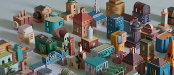 An artwork consisting of a colourful model paper city, with miniature houses and buildings