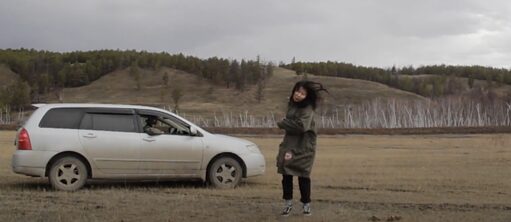 The Right To Be Cold | Still, Svetlana Romanova (Woman dancing in front of a car)