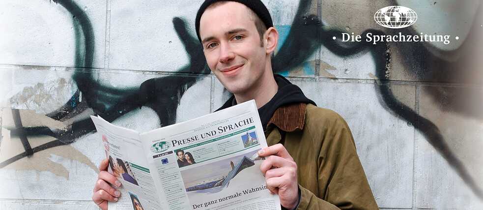 A man reading a newspaper.