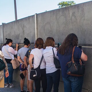 Some people standing at a wall