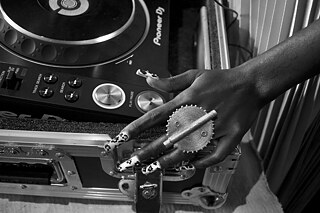 Decorated hand of lady DJ playing a DJ Console. 