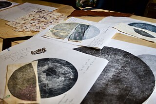 Art and drawings lying spread out on a table