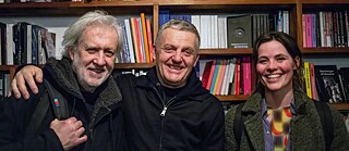 Tony and two musicians hugging and smiling © Dawid Laskowski  Tony Buck at 60: 2