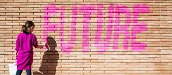 "Future" written in pink on a brick wall