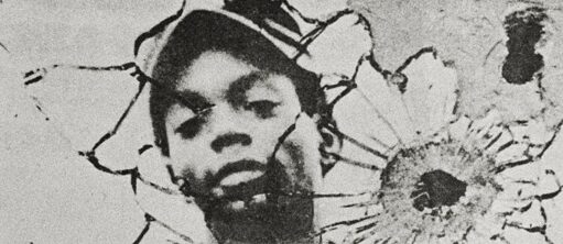 The face of a black boy is visible through the pattern created by gun shot