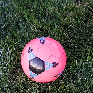 Pink soccer ball on soccer field