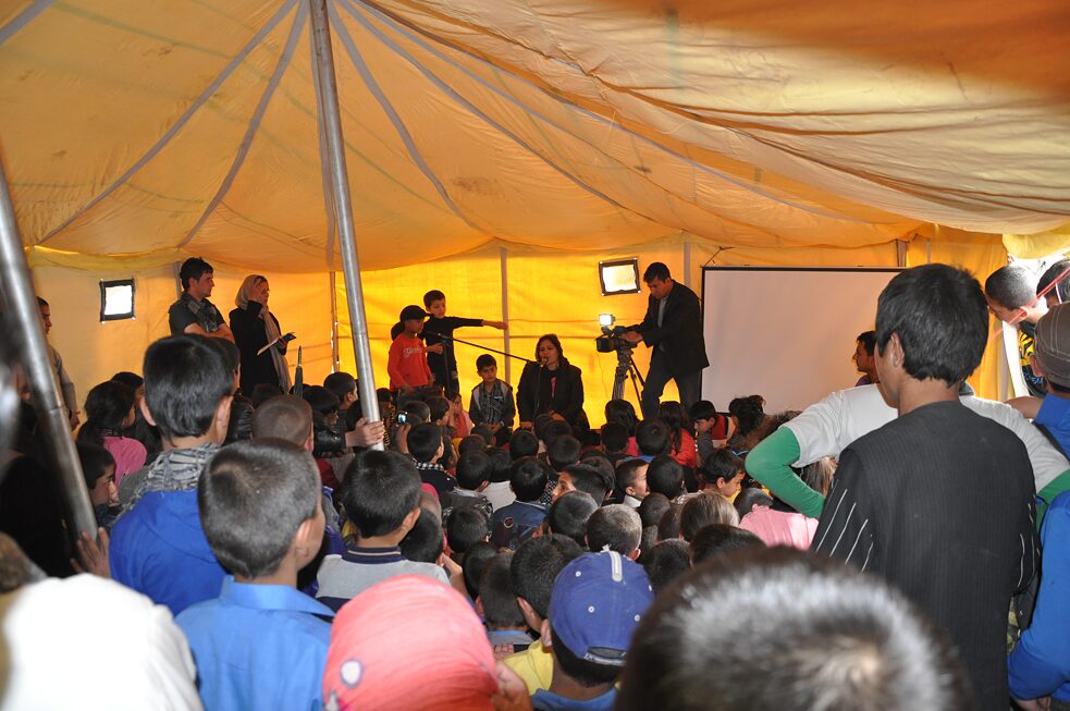 Children and storyteller in a tent