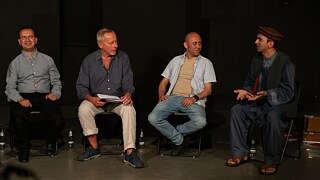 Shir Khan Ahmadzai, Wieland Jagodzinski, Homan Wesa and Abdul Haq Haqjoo sit next to each other. Abdul Haq Haqjoo speaks.