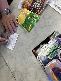 different products on a table, writing hands