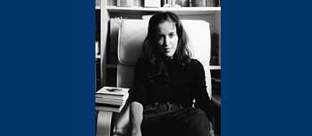 A black and white image of marta sat next to books