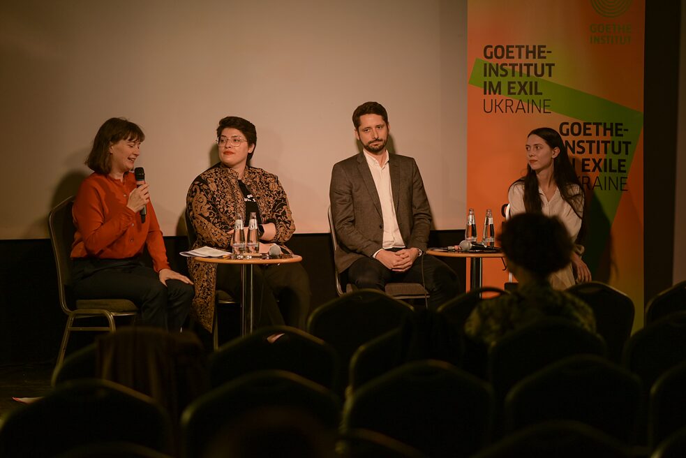 Das Bild zeigt Susann Harder, Sara Nabil, Tobias Busen und Anna Potiomkina, die vier Panelist:innen, die vor dem Publikum sitzen.