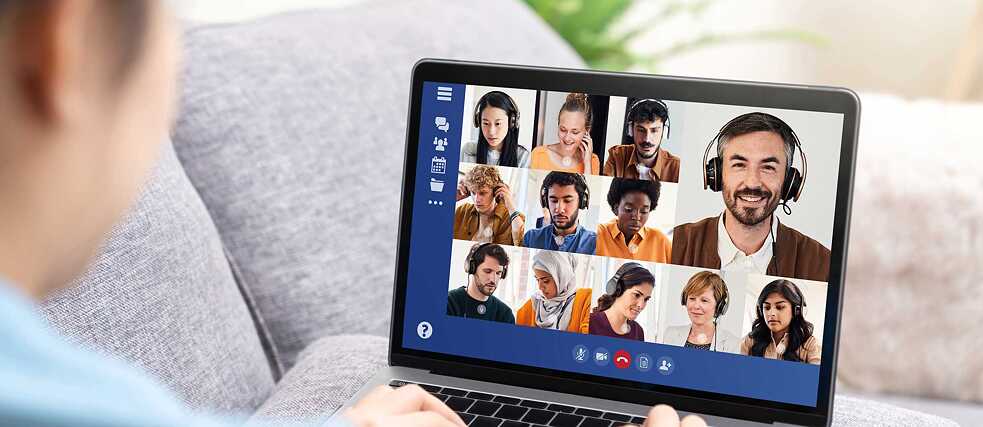 A participant sits on her sofa as she participates in a virtual lesson using a video conference tool.