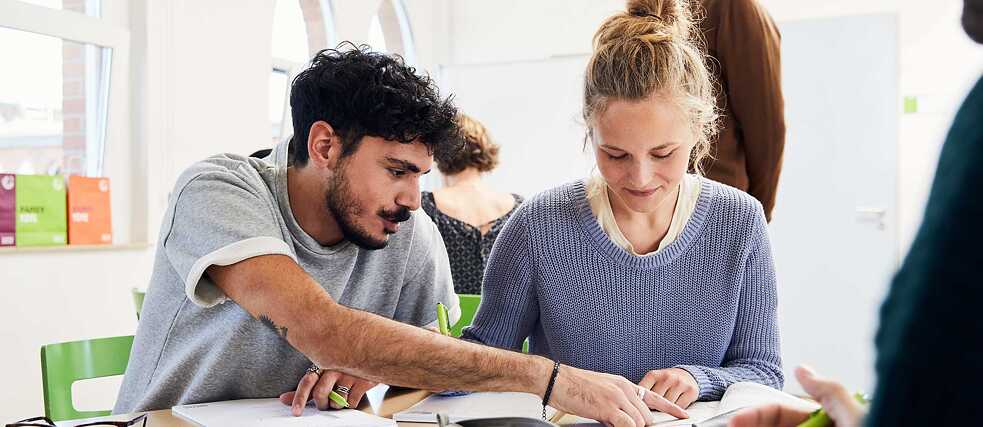 Two students concentrate on a task during a language class.