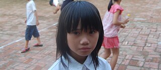 Photo showing a portrait of a young Vietnamese girl.
