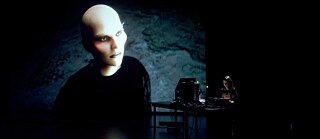 AI Art next to Nazanin Noori performing behind DJ booth  © Udo Siegfriedt  Diana Azzuz & Nazanin Noori (Ridne - Rybachka) 