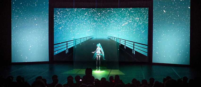Ein Bild von einer Anime-KI-Installation mit Publikum davor 