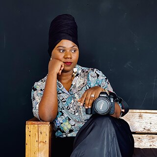 A portrait image of Pamela with a camera in her hands