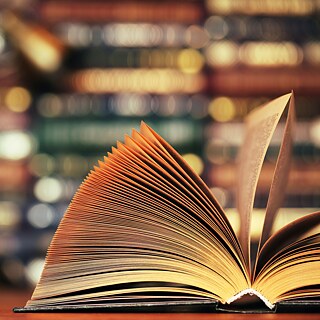 An open book lies on a table.