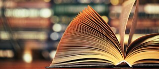 An open book lies on a table.