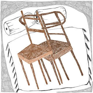 Two chairs lying close together in bed