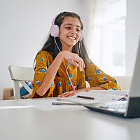 Mädchen sitzen beim Laptop