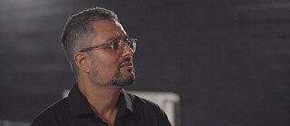 Martin Ganguly in profile against a gray background